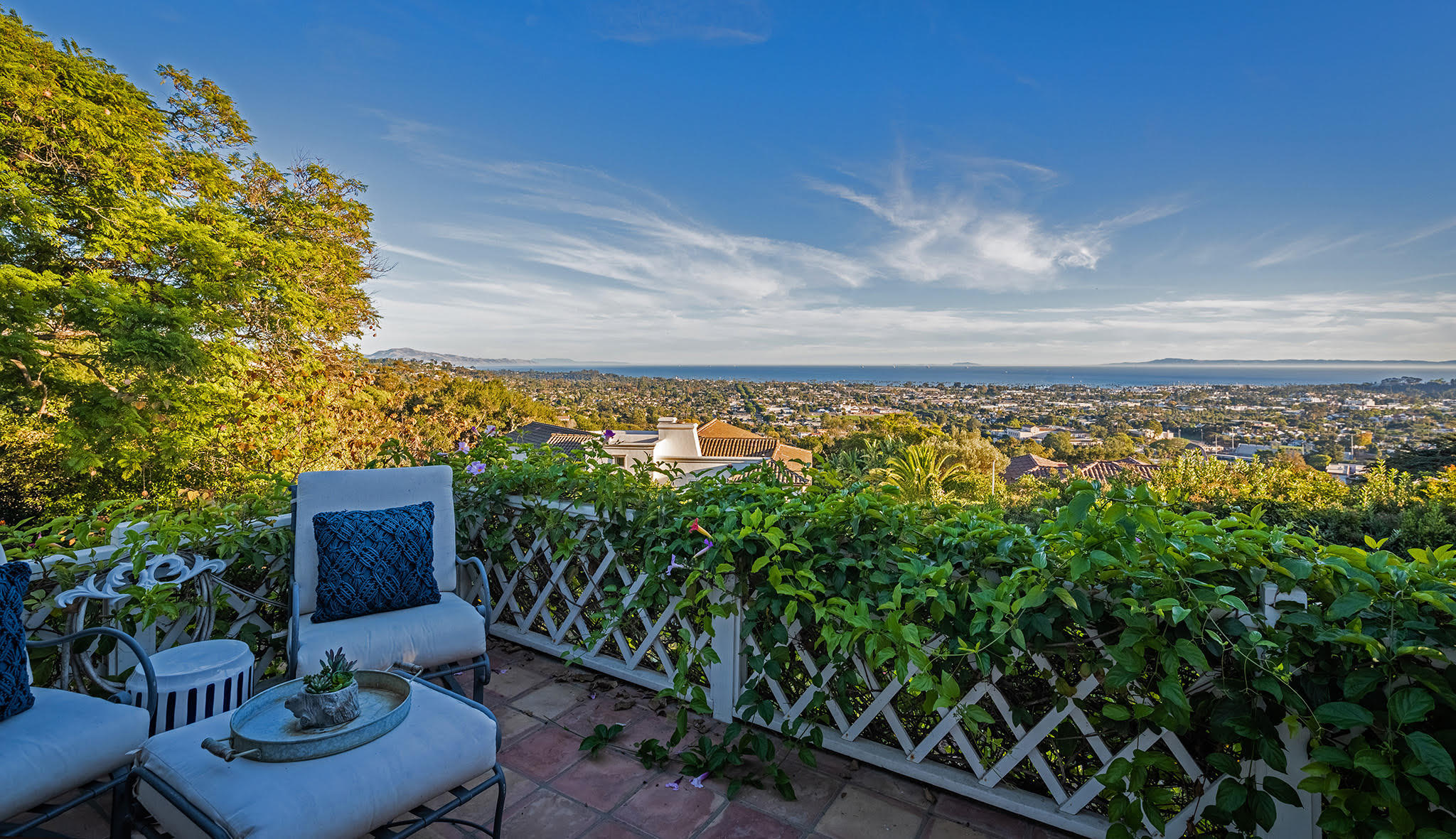 a view of a chair and table in the backyard