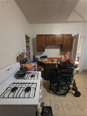 a kitchen with a stove and a wooden floor