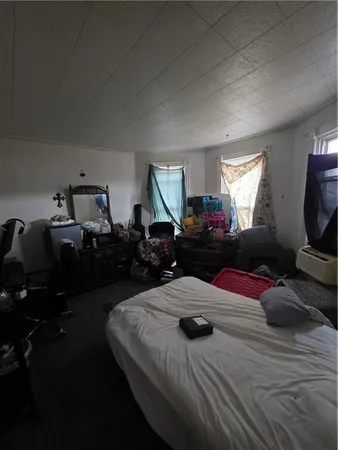 a bedroom with furniture and a mirror