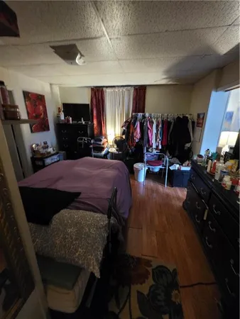 a bed room with a bed mirror and a chair