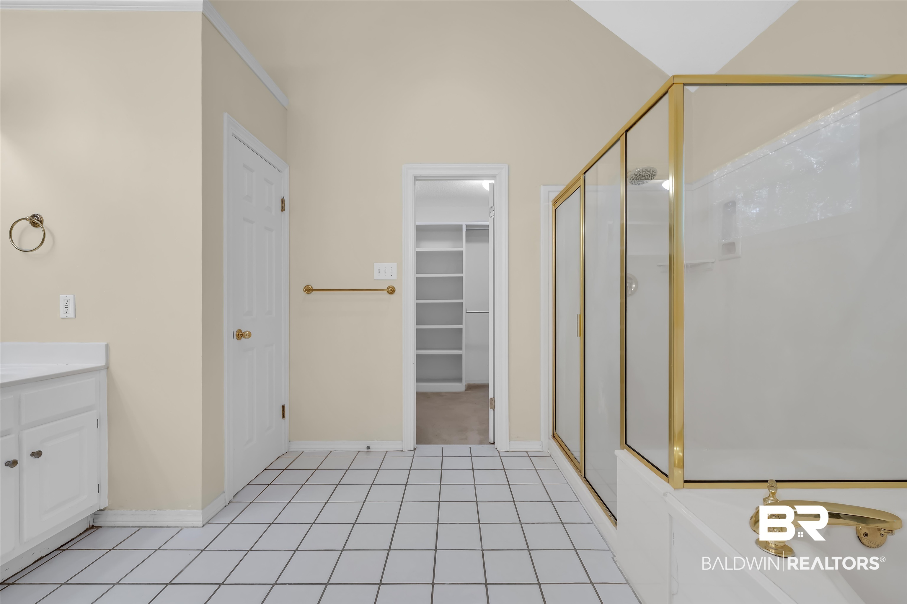 1262 Patrick Street Daphne, AL 36526 - Photo 32 of 35 Full bathroom with a walk in closet, a shower stall, vanity, a garden tub, and light tile patterned floors