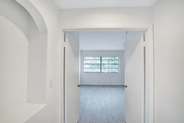 a view of room with window and wooden floor