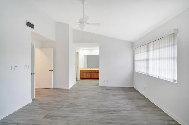 a view of room with window and wooden floor
