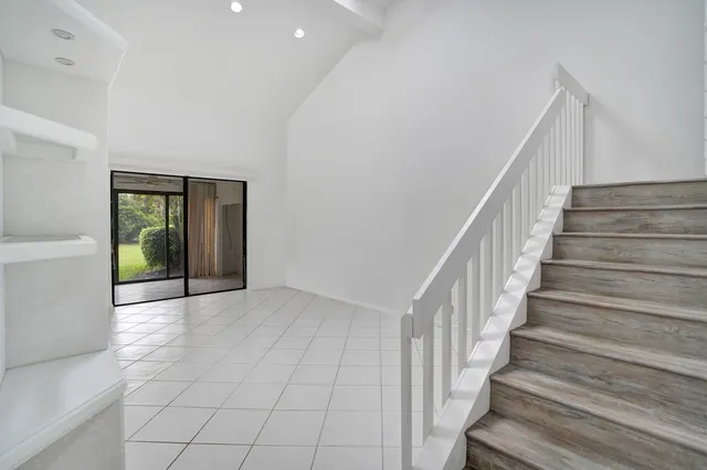a view of an entryway with wooden floor and a livingroom view