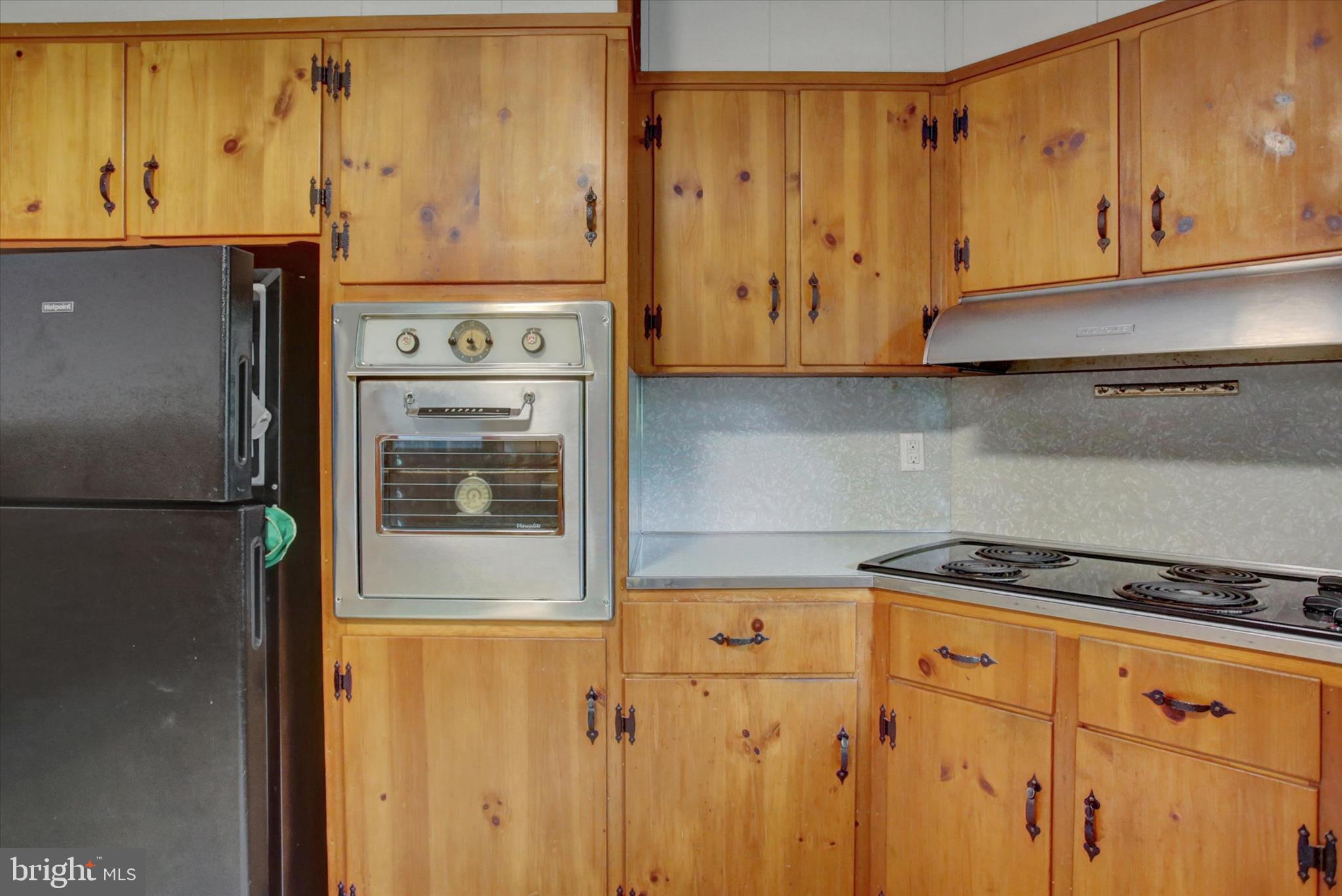 5156 Peach Orchard Road McConnellsburg, PA 17233 - Photo 12 of 34 a kitchen with granite countertop cabinets and a stove top oven