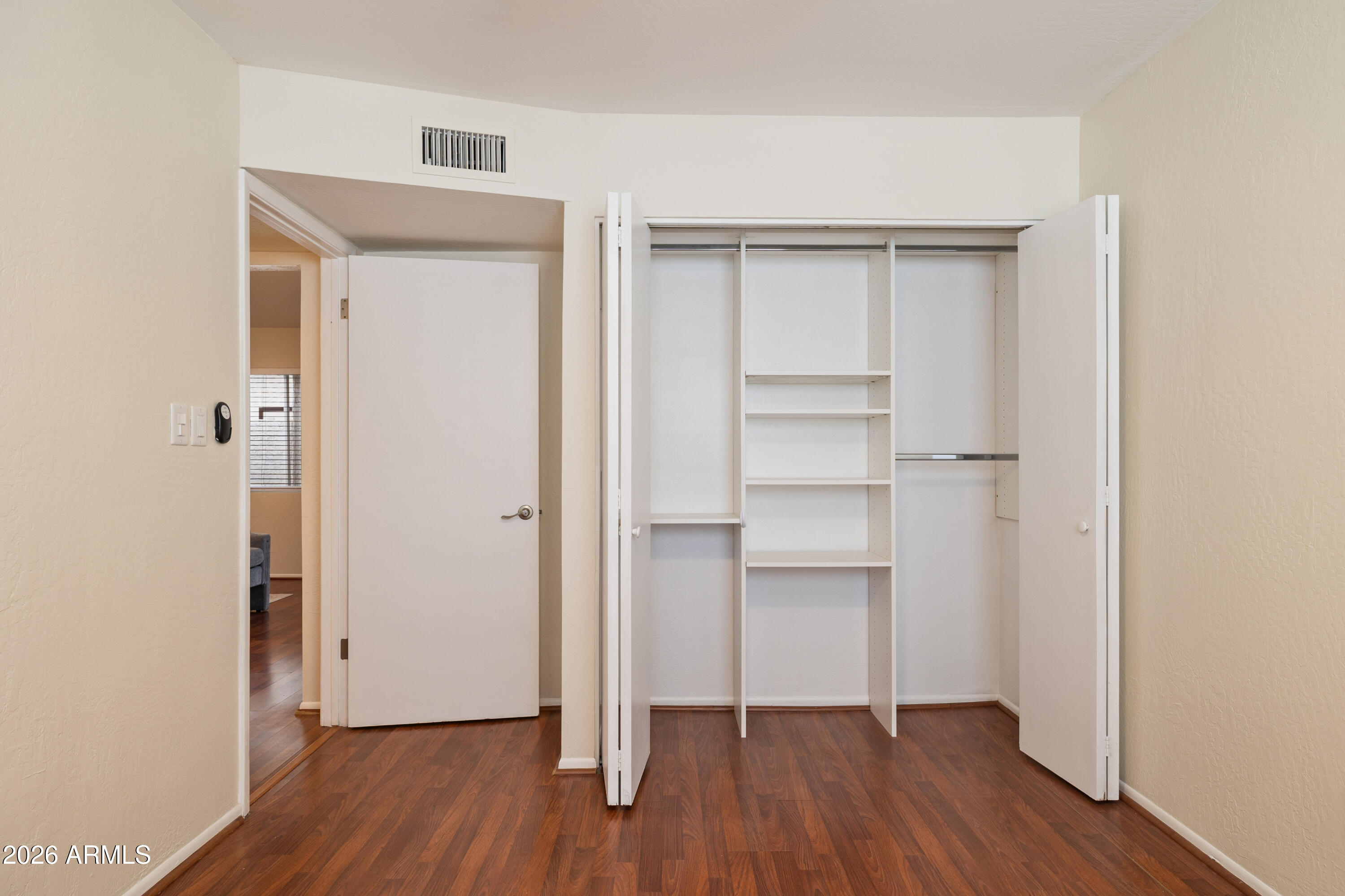 4343 East Osborn Road Phoenix, AZ 85018 - Photo 18 of 41 a view of empty room with wooden floor