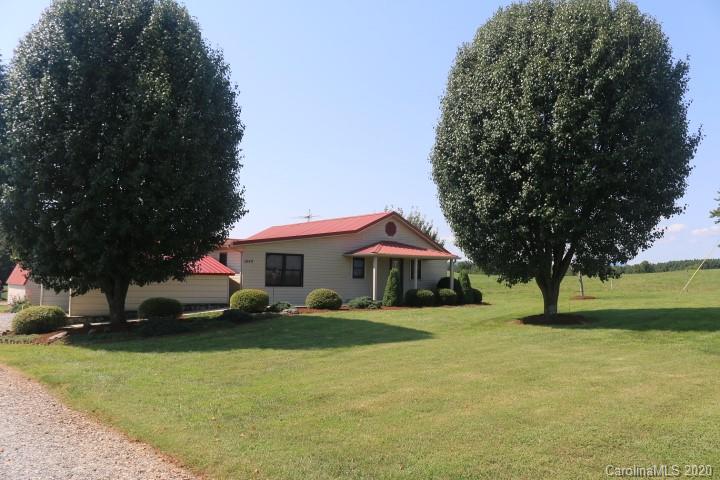 1949 Huckleberry Ridge Road Hiddenite, NC 28636 - Photo 1 of 31 a front view of a house with garden