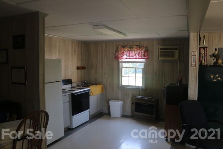 1949 Huckleberry Ridge Road Hiddenite, NC 28636 - Photo 29 of 31 a kitchen with a refrigerator and a stove top oven