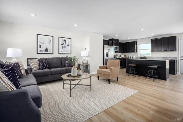 a living room with furniture a rug and a flat screen tv