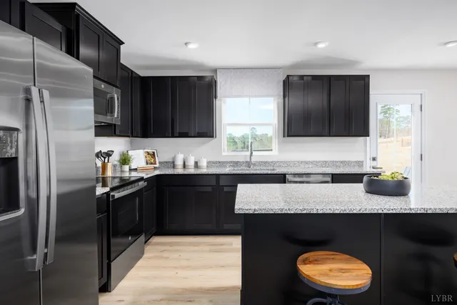 a kitchen with granite countertop stainless steel appliances and wooden cabinets