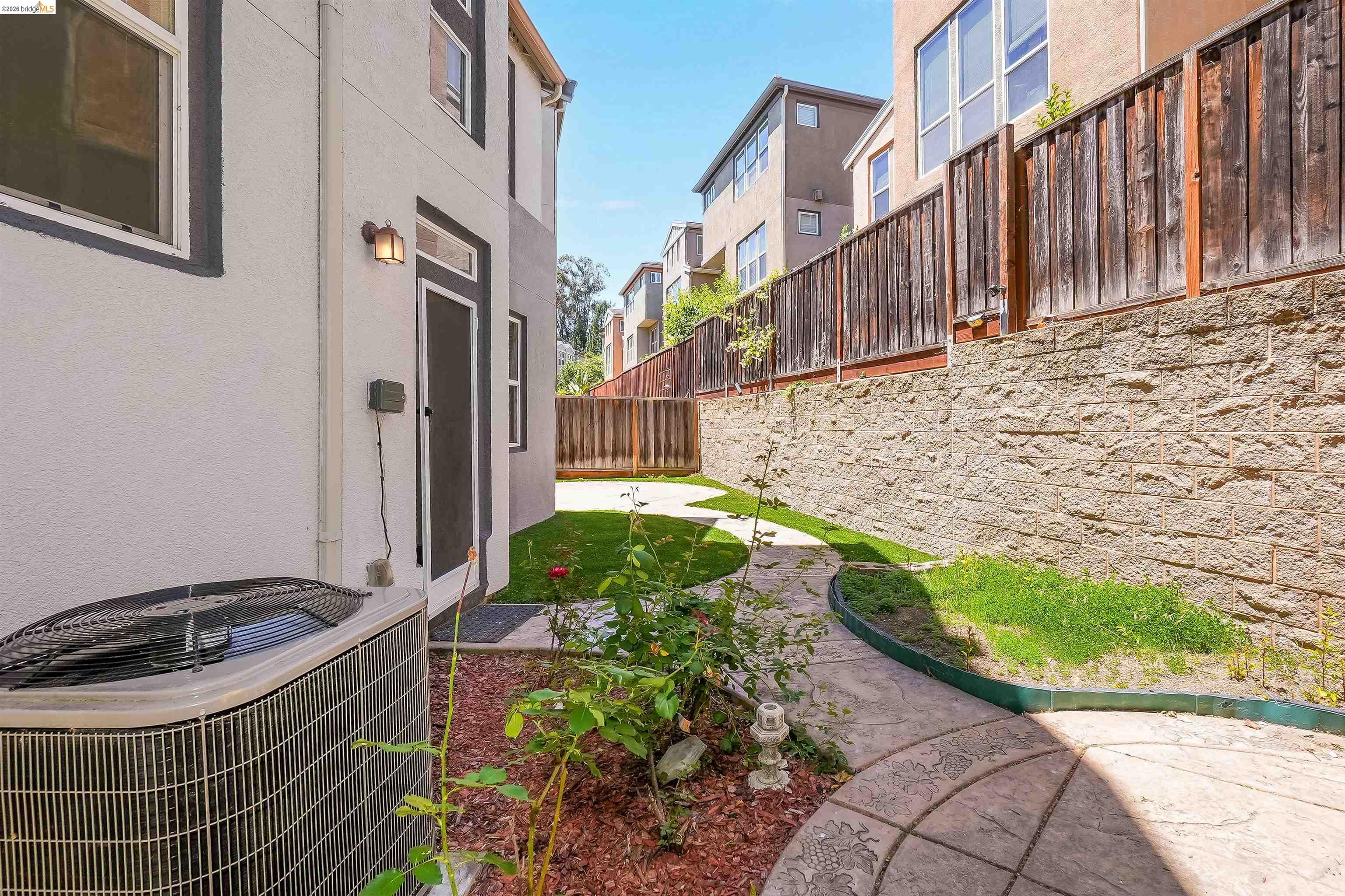449 Constantine Court San Ramon, CA 94583 - Photo 54 of 63 Private yard featuring a stamped concrete pathway, manicured lawn, and mature planter beds