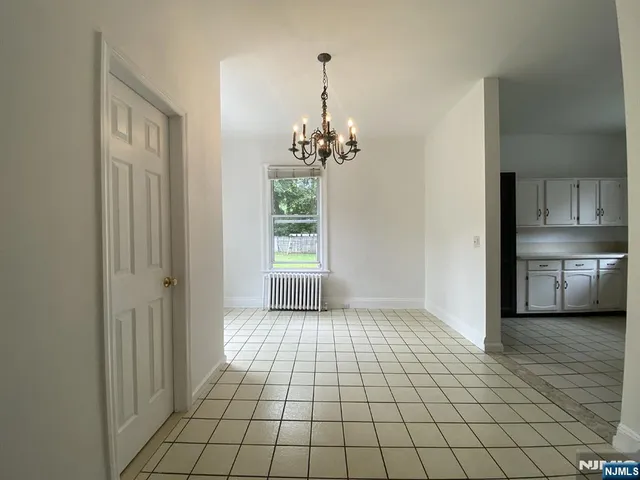 a view of a room with window and wooden floor