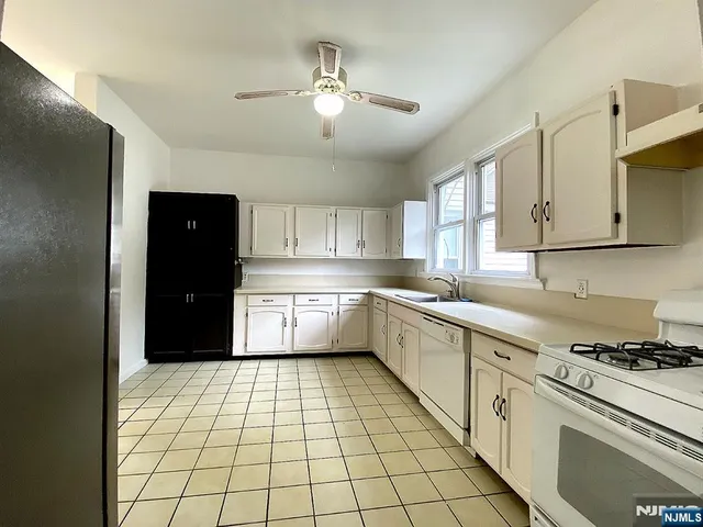a kitchen with a white cabinets and white appliances