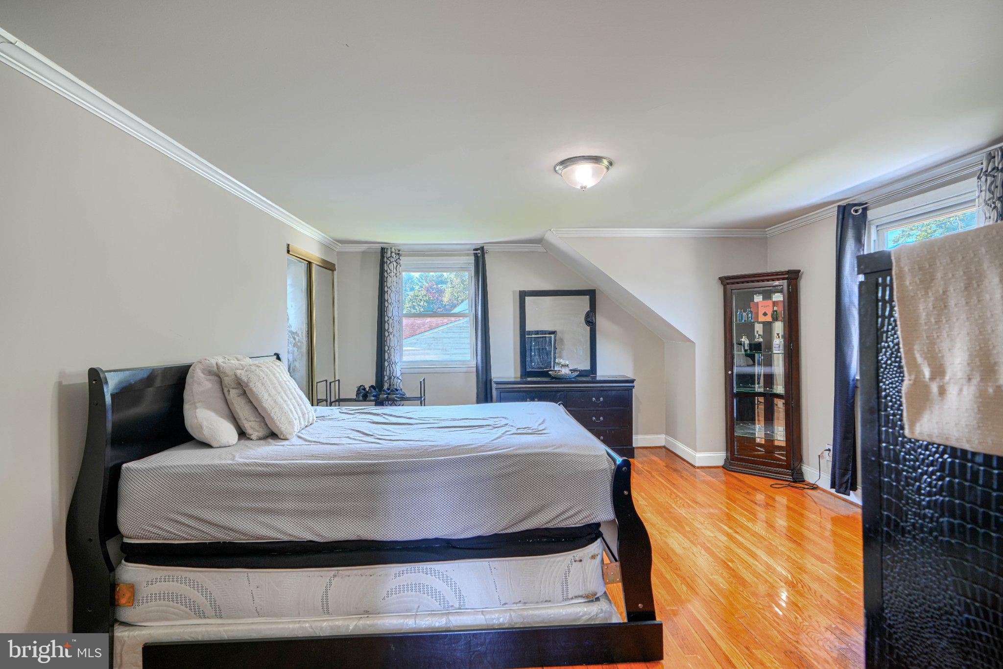 3708 Cassen Road Randallstown, MD 21133 - Photo 24 of 38 a bedroom with a bed and wooden floor
