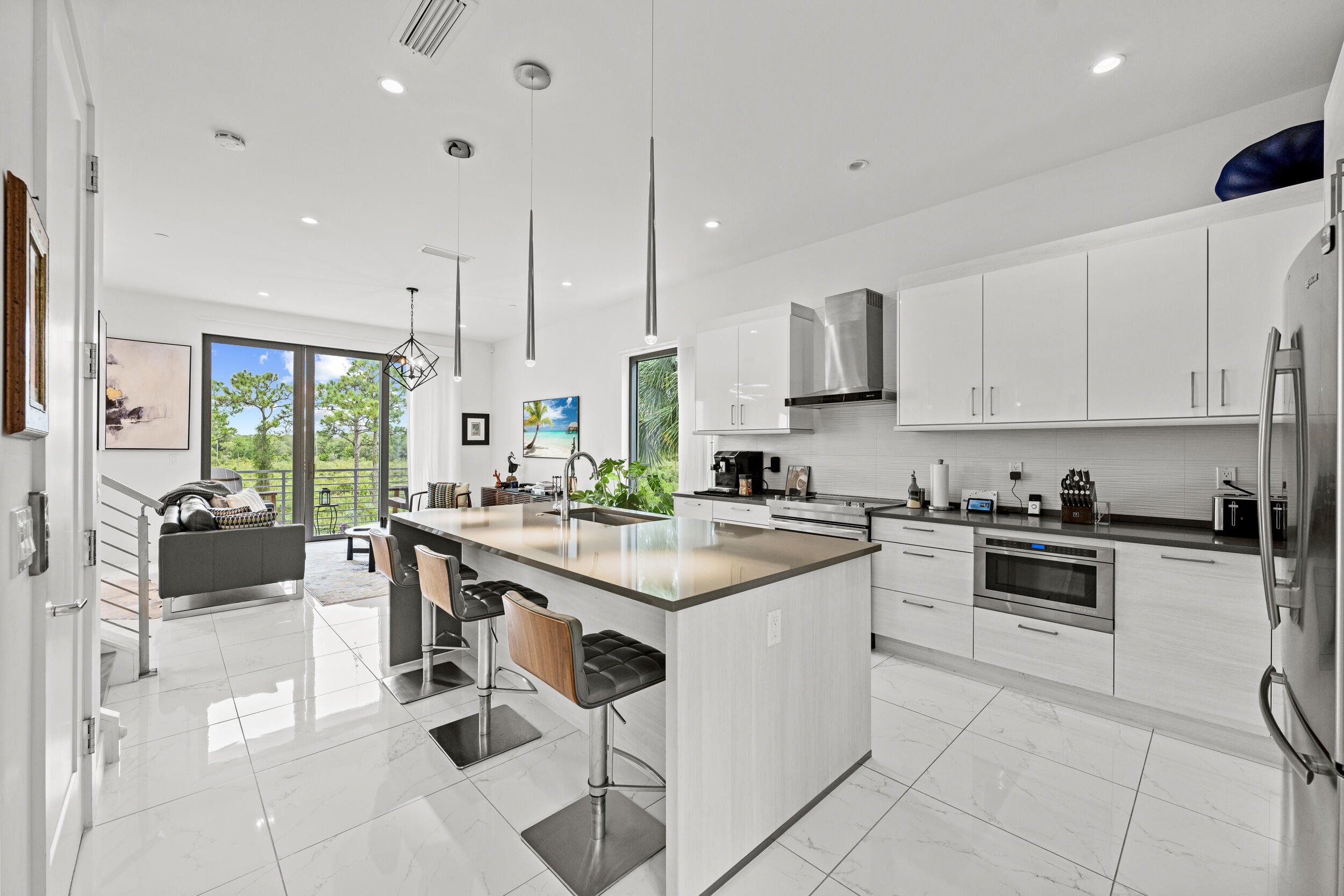 1811 Northwest 42nd Drive Boca Raton, FL 33431 - Photo 1 of 51 a kitchen with white cabinets and white appliances