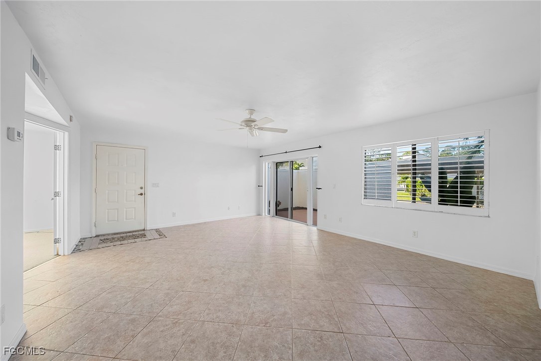 3052 Kings Lake Boulevard, Unit 7554 Naples, FL 34112 - Photo 11 of 32 a view of an empty room with a window