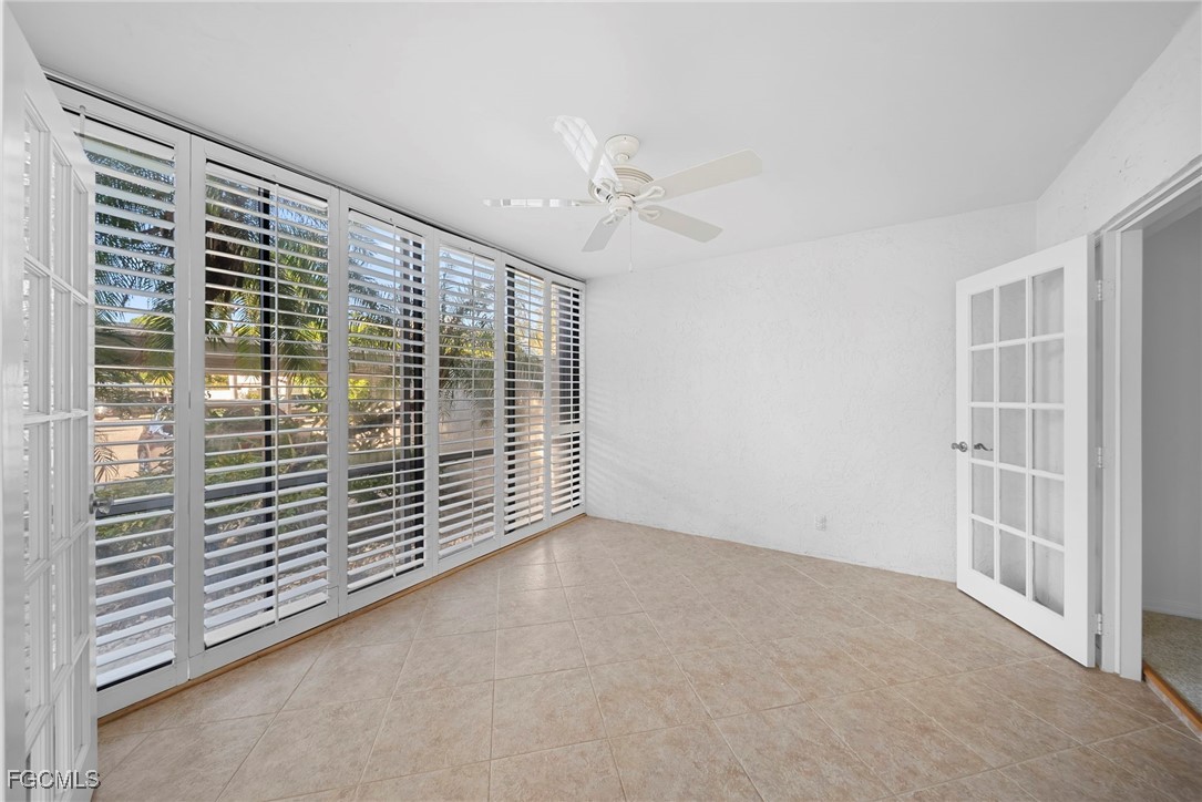 3052 Kings Lake Boulevard, Unit 7554 Naples, FL 34112 - Photo 13 of 32 a view of an empty room with a window
