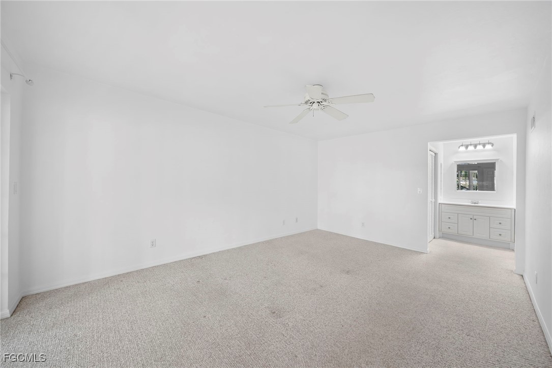 3052 Kings Lake Boulevard, Unit 7554 Naples, FL 34112 - Photo 16 of 32 a view of an empty room with a window