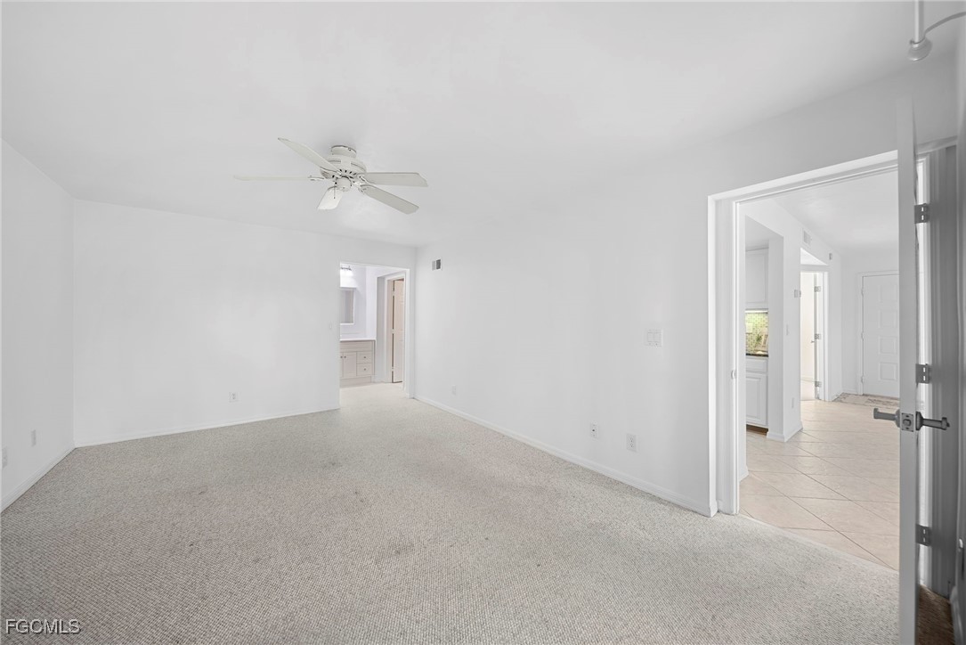 3052 Kings Lake Boulevard, Unit 7554 Naples, FL 34112 - Photo 17 of 32 wooden floor in an empty room