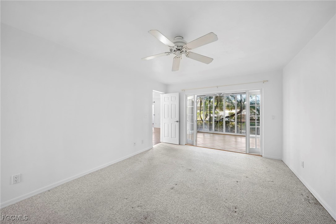 3052 Kings Lake Boulevard, Unit 7554 Naples, FL 34112 - Photo 18 of 32 a view of a big room with windows and chandelier fan