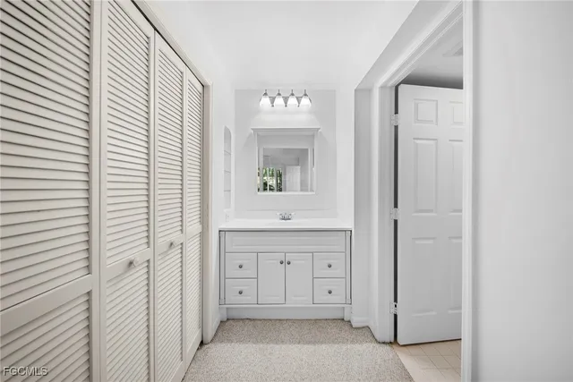 a bathroom with a granite countertop sink a vanity and a mirror
