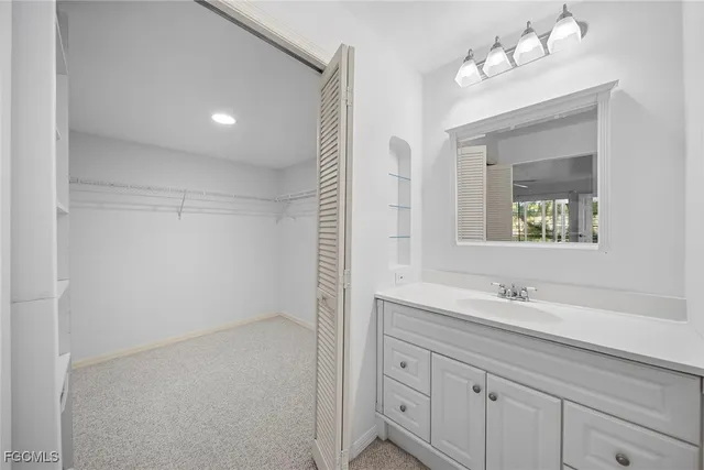a bathroom with a sink vanity and mirror