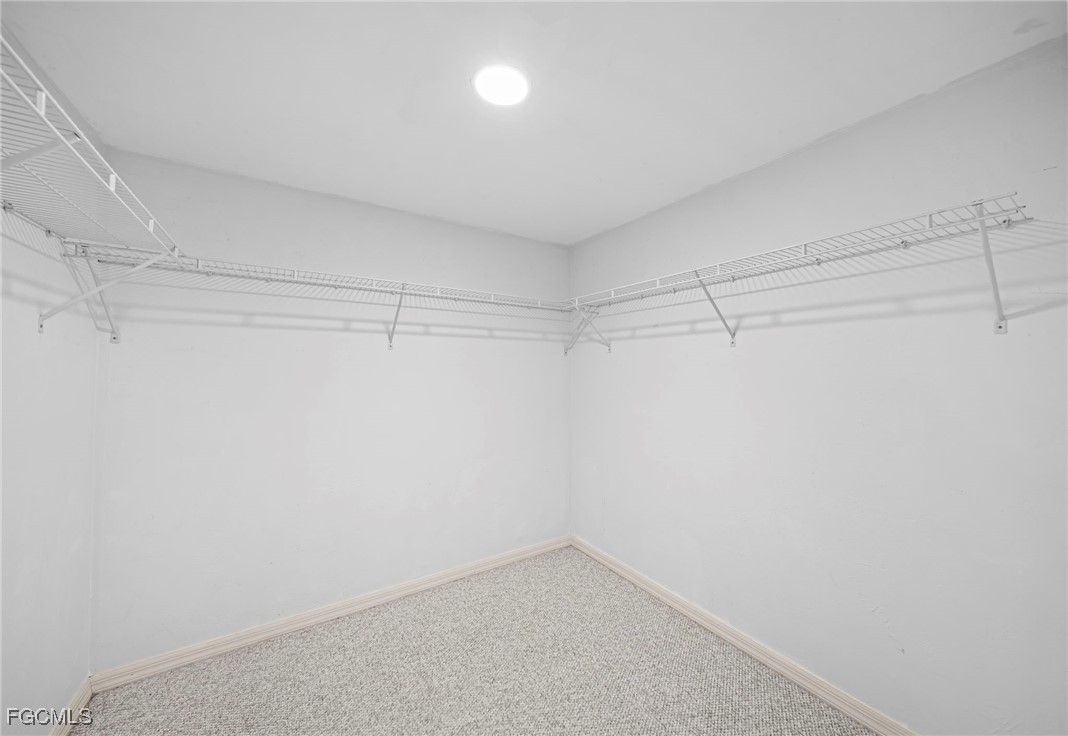 3052 Kings Lake Boulevard, Unit 7554 Naples, FL 34112 - Photo 21 of 32 a view of a room with racks on the wall