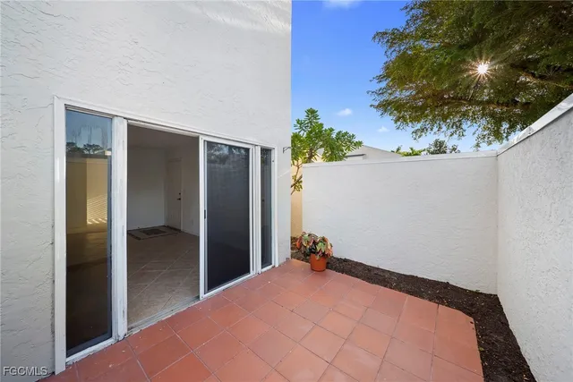a bedroom with a bed and a potted plant