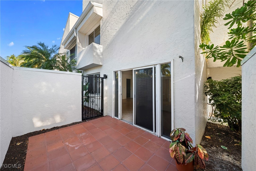 3052 Kings Lake Boulevard, Unit 7554 Naples, FL 34112 - Photo 28 of 32 a bedroom with a bed and a potted plant