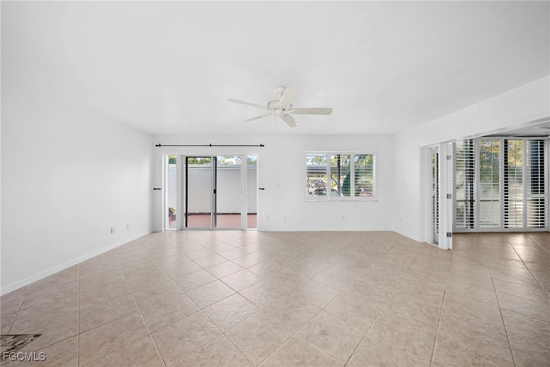 3052 Kings Lake Boulevard, Unit 7554 Naples, FL 34112 - Photo 6 of 32 an empty room with windows and entrance