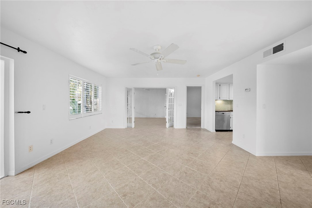 3052 Kings Lake Boulevard, Unit 7554 Naples, FL 34112 - Photo 8 of 32 a view of an empty room with a window