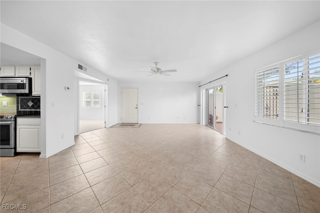 3052 Kings Lake Boulevard, Unit 7554 Naples, FL 34112 - Photo 10 of 32 a view of an empty room with a window