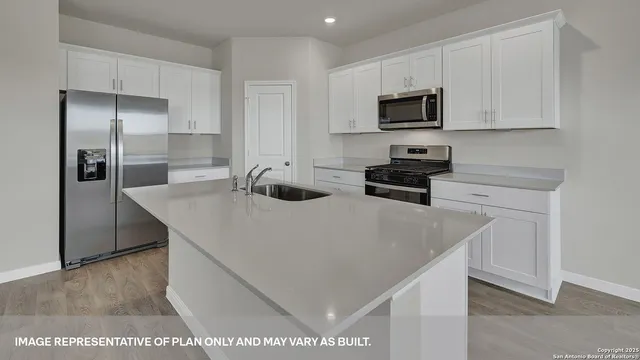 a kitchen with stainless steel appliances a stove a microwave a sink and cabinets