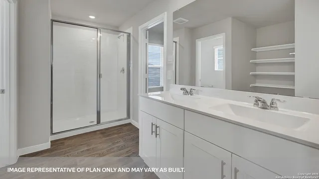 a bathroom with double vanity sinks and a mirror