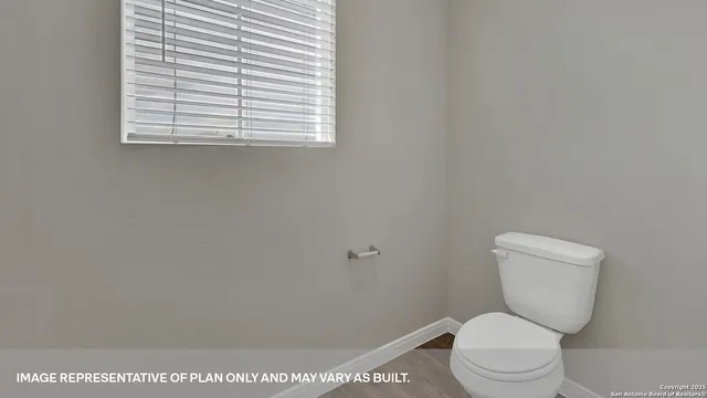 a white toilet sitting next to a window