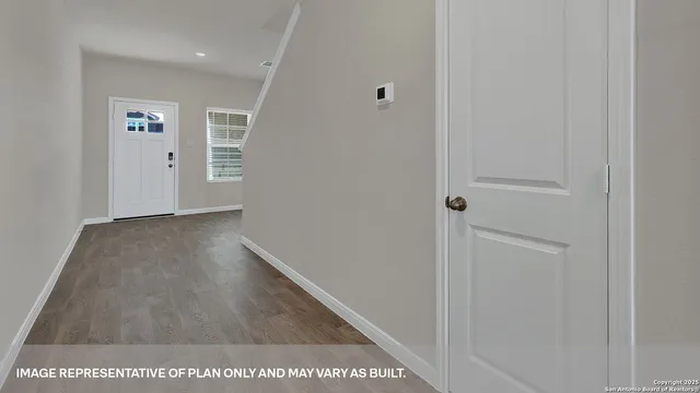 a view of hallway with wooden floor