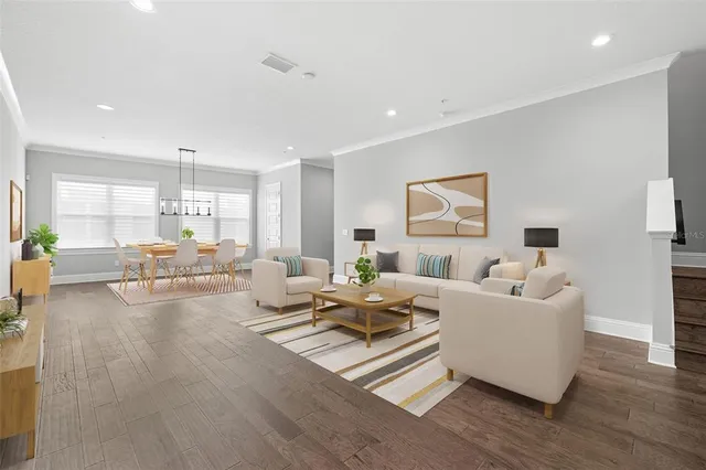 a living room with furniture and wooden floor