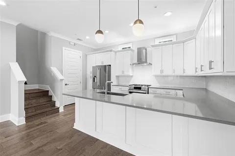 a kitchen with stainless steel appliances sink refrigerator and cabinets