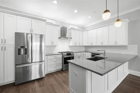 a kitchen with a center island and stainless steel appliances