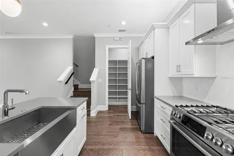 a kitchen with granite countertop a sink stainless steel appliances and cabinets