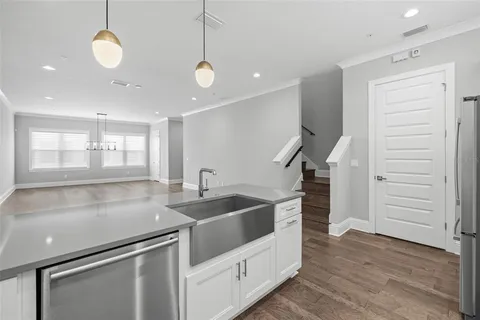 a kitchen with stainless steel appliances granite countertop a sink stove and cabinets