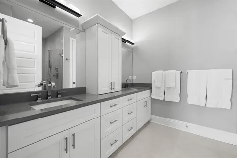 a bathroom with a glass shower door