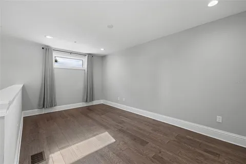 a living room with furniture gym equipment and view of kitchen