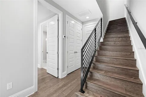 a view of a hallway with wooden floor and entryway