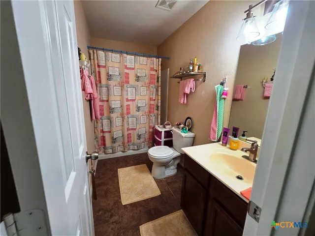 a bathroom with a sink vanity mirror and tub