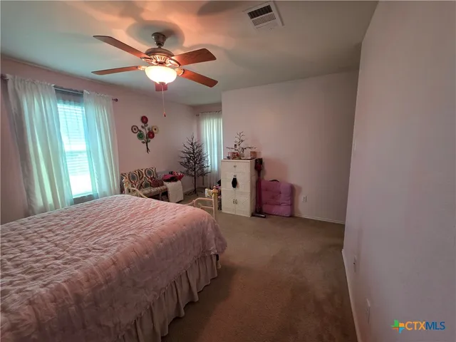 a bed room with a bed and a chandelier