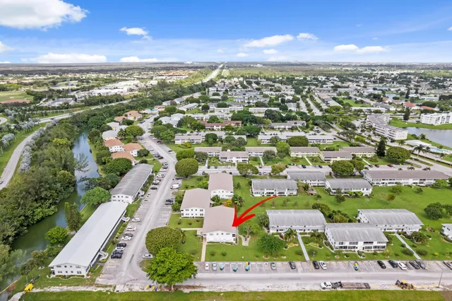 an aerial view of residential building with swimming pool and ocean view