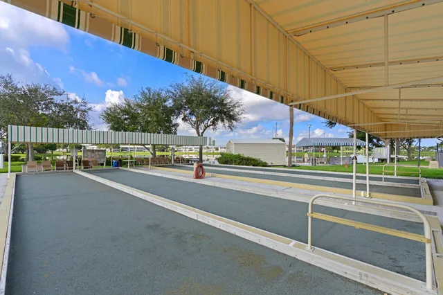 a view of a city street with a car parked in front of it