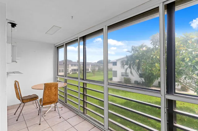 a living room with furniture a fireplace and a chandelier