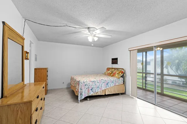 a view of a bedroom with a bed and wooden floor